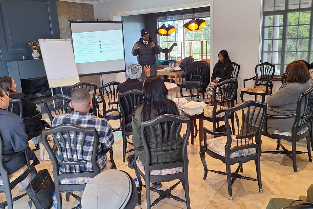 A facilitator presenting to a cohort of educators seated in a circle during a leadership session