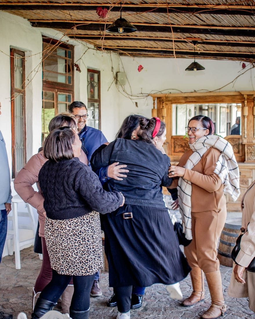 School leaders laughing and embracing during an icebreaker at a Dinaledi workshop